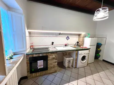 a kitchen with a sink and a washing machine at Mandarhouse Dante in Palermo