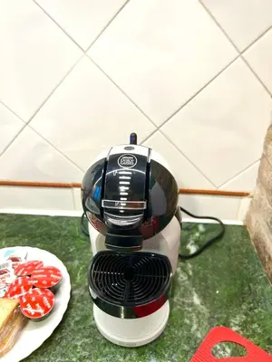 a coffee maker on a counter next to a plate of food at Mandarhouse Dante in Palermo