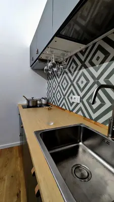 a kitchen with a sink and a counter top at Disìu Apartment con Jacuzzi in centro a Castellammare del Golfo in Scopello