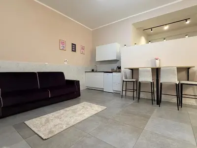 a living room with a bar and a tv on the wall at Loft Al Massimo in Palermo
