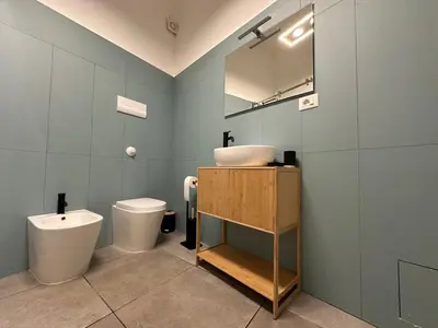 a bathroom with a toilet and a sink and a shower at Loft Al Massimo in Palermo