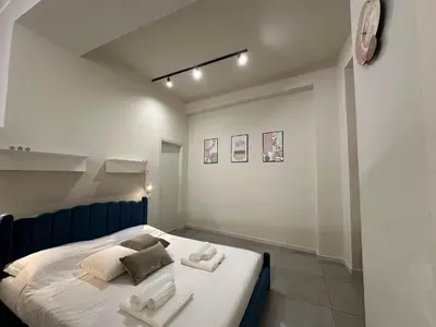 a kitchen with a table and four chairs at Loft Al Massimo in Palermo