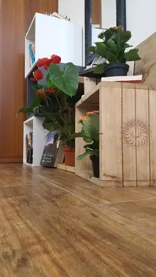 a wooden box with potted plants on the floor at Oasi del Libro in Castellammare del Golfo