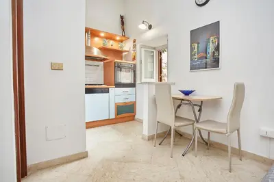 a kitchen with a table and chairs in it at A 2 passi dal Teatro Massimo in Palermo