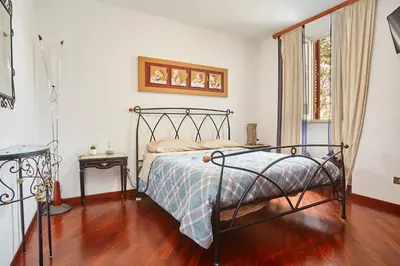 a bedroom with a bed with a metal bed frame at A 2 passi dal Teatro Massimo in Palermo