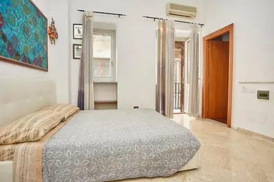 a bedroom with a bed and a painting on the wall at A 2 passi dal Teatro Massimo in Palermo