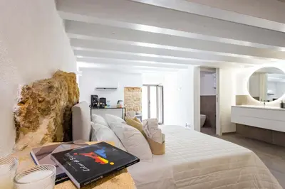 a bedroom with a bed with a book on it at La Camera di Carolino in Palermo