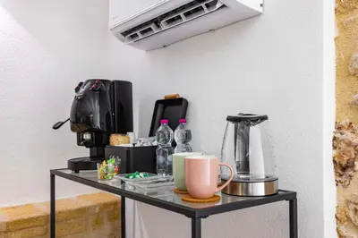 a table with a coffee maker on it at La Camera di Carolino in Palermo
