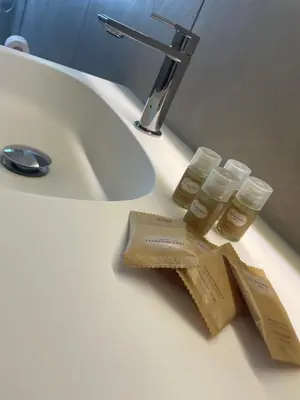a bathroom sink with two bottles of honey on it at Il Sole di Palermo in Palermo