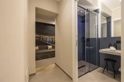 a bathroom with a glass door leading to a bedroom at Lolli Boutique & SPA Mondello in Palermo