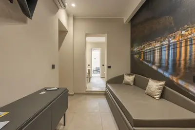 a living room with a couch and a painting on the wall at Lolli Boutique & SPA Mondello in Palermo