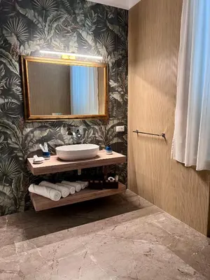 a bathroom with a sink and a mirror at Fervore Luxury Rooms-Apartments in Palermo