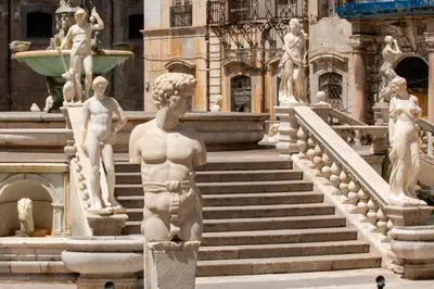 a statue in front of a building with stairs at A casa di Maria in Palermo