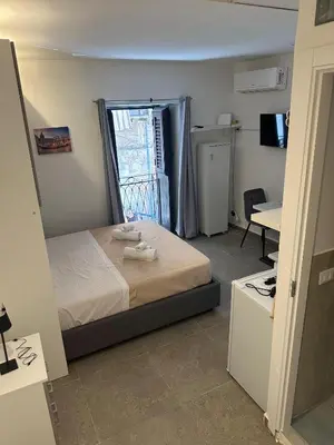a bedroom with a bed with two towels on it at A casa di Maria in Palermo