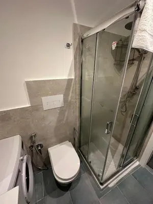 a bathroom with a shower and a white toilet at A casa di Maria in Palermo