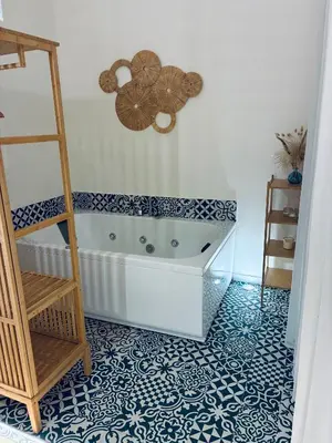 a bath tub in a bathroom with a black and white tile floor at Disíu Apartment con jacuzzi in pieno centro in Castellammare del Golfo