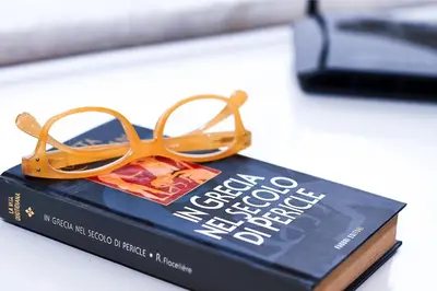 a pair of glasses sitting on top of a book at Palermo al Centro - Appartamento Fiume in Palermo