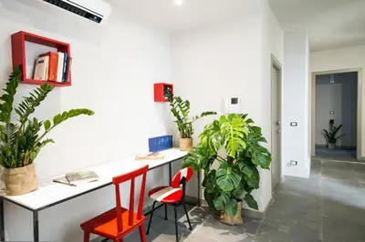 an office with a desk and two chairs and plants at Cassaro261 in Palermo