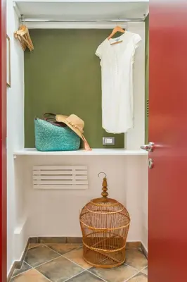 a closet with a white shirt and a basket on a shelf at Cassaro261 in Palermo