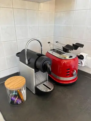 a kitchen counter with a red toaster on the counter at Le Lunette Holiday House in Palermo