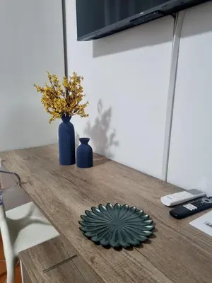 a table with a blue vase and a plate on it at Casa Marì-Albergheria in Palermo's historic center in Palermo