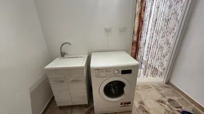 a laundry room with a washing machine and a sink at La casetta di Totò in Palermo