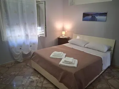 a bedroom with a bed with two towels on it at Casa Lety in Palermo