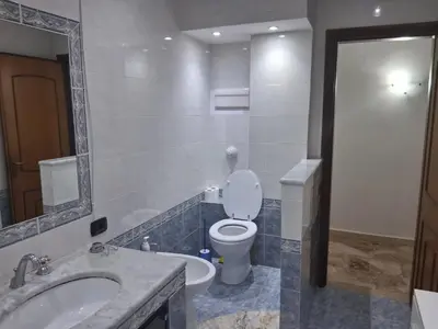 a bathroom with a toilet and a sink and a mirror at Casa Lety in Palermo