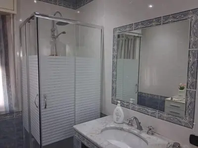 a bathroom with a sink and a shower with a mirror at Casa Lety in Palermo