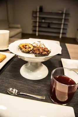 a plate of food on a table with a bowl of food at Home In City in Palermo