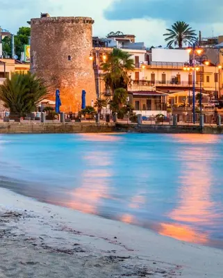 a view of the beach in front of a castle at Antony Mondello Guest House, appartamento a 1 minuto a piedi dalla spiaggia di Mondello in Palermo