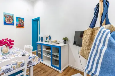 a dining room with a table and a blue and white towel at Antony Mondello Guest House, appartamento a 1 minuto a piedi dalla spiaggia di Mondello in Palermo