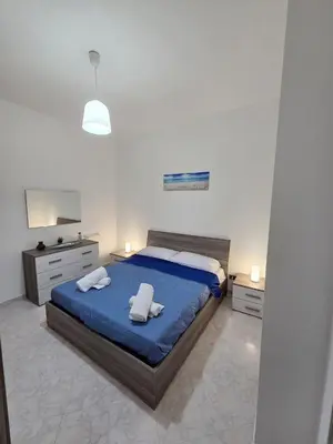 a bedroom with a bed with two towels on it at Casa Pino in Isola delle Femmine