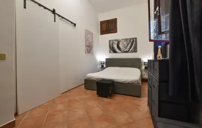 a small bedroom with a bed and a dresser at Nice Home In Capaci With Wifi in Capaci