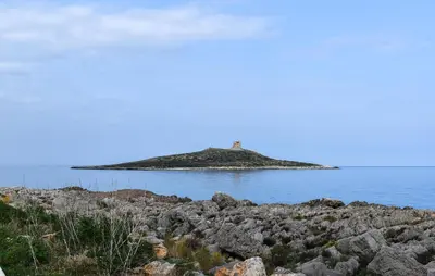 an island in the water with a lighthouse on it at Nice Home In Capaci With Wifi in Capaci
