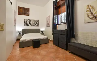 a small bedroom with a bed and a window at Nice Home In Capaci With Wifi in Capaci