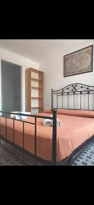 a bedroom with a large bed with orange sheets at Vista mare 360 in Scopello