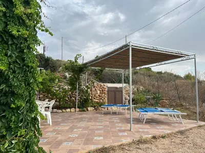 a pavilion with two picnic tables on a patio at Vista mare 360 in Scopello