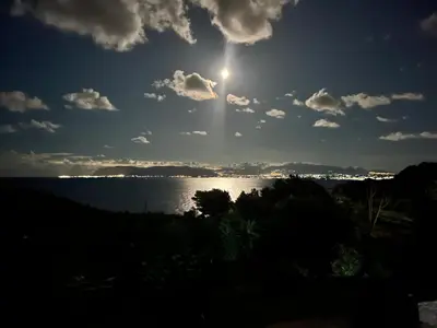 a sun shining over a body of water at Vista mare 360 in Scopello