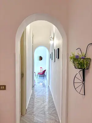 a hallway with an archway in a house at Chic Angolo di Anita in Palermo