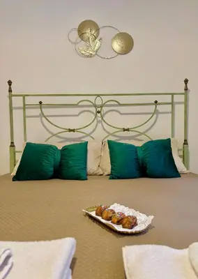 a bed with a plate of food on it at Chic Angolo di Anita in Palermo