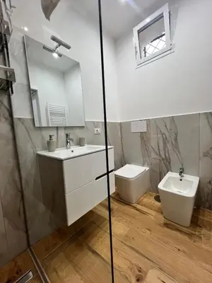a bathroom with a sink and a toilet at Kiccifù home in Palermo