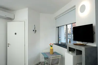 a bedroom with a bed and a vase with flowers at Anciovi Rooms in Bagheria