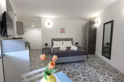 a bedroom with a bed with two white pillows at Anciovi Rooms in Bagheria
