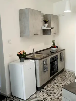 a small kitchen with a sink and a stove at Anciovi Rooms in Bagheria