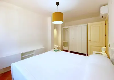 a large white bedroom with a large white bed at Solemar Sicilia - Villa Alma in Palermo
