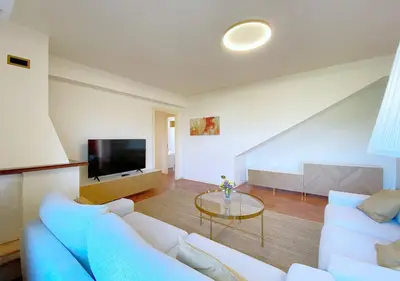 a living room with a blue couch and a table at Solemar Sicilia - Villa Alma in Palermo