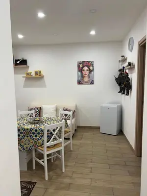 a small kitchen with a table and a table and a table and a table at Oasi house in Palermo