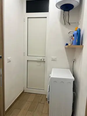 a white door in a small room with a toilet at Oasi house in Palermo
