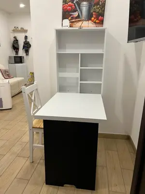 a white and black desk in a room with a chair at Oasi house in Palermo
